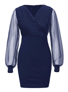 Detail of navy blue V-neck dress with sequin bodice and sheer mesh lantern sleeves