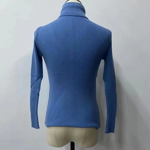 Rear view of a slim fit blue turtleneck knit sweater with vertical ribbing on a mannequin