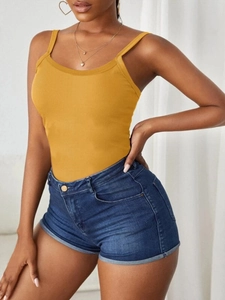 Detail shot of ginger yellow ribbed knit tank top with thin straps and scoop neckline