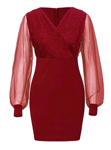 Detail of burgundy V-neck dress featuring sequined bodice and sheer mesh lantern sleeves