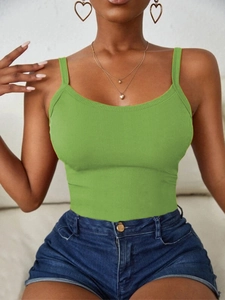 Detail of green ribbed knit tank top paired with denim shorts and gold heart earrings