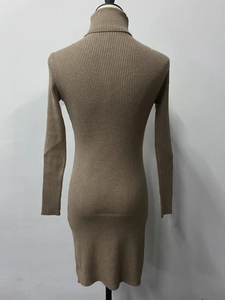 Detail of high neck ribbed knit dress showing vertical texture and slim fit design