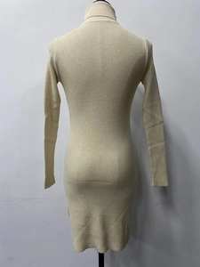 Close-up of ribbed knit texture on a beige long-sleeve slim fit turtleneck dress