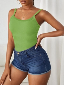 Close-up of grass green ribbed knit camisole with thin straps and a slim-fit design