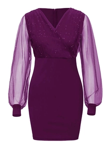 Close-up of elegant V-neck mesh dress with sparkling sequins and sheer long lantern sleeves