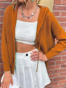 Detail shot of a burnt orange knitted hooded cardigan with buttons and thick texture