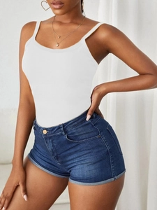 Detailed texture of white ribbed knit camisole top paired with cuffed denim shorts