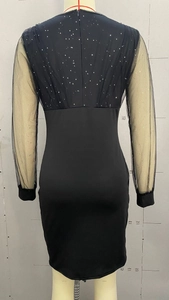 Close-up of the black mesh back and silver sequins on this slim fit evening dress