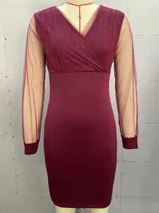 Detail of V-neck sequined mesh sleeves and burgundy body on bodycon dress