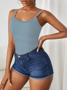 Detailed texture of blue ribbed knit camisole top paired with denim shorts