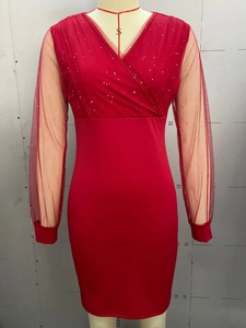 Detail of red V-neck sequined mesh bodice and long sleeves on a slim cocktail dress