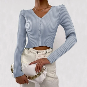 Detailed view of the ribbed texture and button closure on the sky blue knit cardigan
