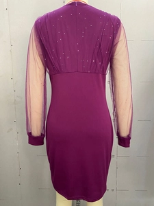 Detail of purple sequin dress showing sheer mesh sleeves and slim fit back design