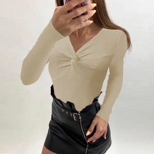 Detailed view of beige ribbed knit sweater featuring a stylish twist V-neck design