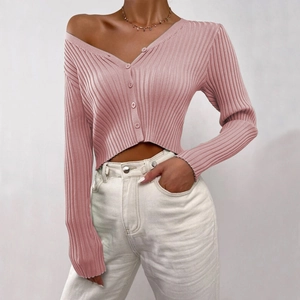 Detail shot of pink ribbed knit cardigan texture with button closure and V-neckline