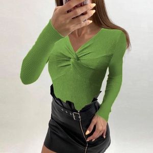 Close-up of grass green V-neck knit sweater with twist-front design and ribbed texture