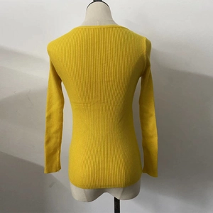 Detailed back view of a yellow ribbed knit sweater showing fine texture and slim fit