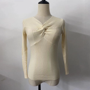 Close-up of the elegant twist knot detail and V-neckline on this ribbed knit sweater