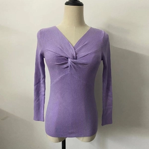 Close-up of lavender V-neck knit top featuring a unique cross-knot design and ribbed texture