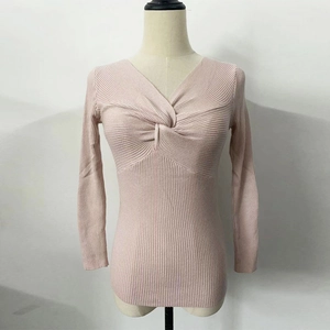 Detail of pink long sleeve knit sweater showing deep V-neck and twist knot design