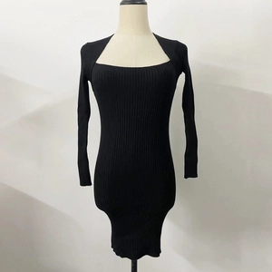 Close-up of black ribbed knit long sleeve dress featuring a square neckline and slim fit