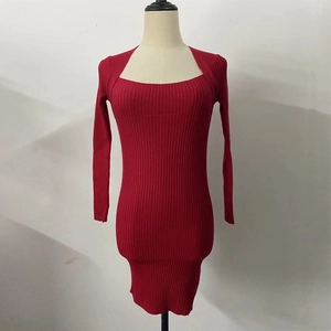 Detail of red long sleeve knit dress with square neck and vertical ribbed texture on mannequin