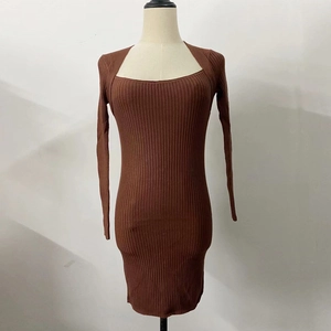 Detail of square neckline and ribbed knit texture on a slim fit brown sweater dress
