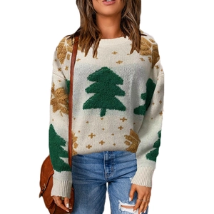 Detailed view of 3D textured green Christmas tree embroidery on white knit sweater