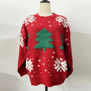 Detail of red Christmas sweater with green flocked tree and white snowflake embroidery