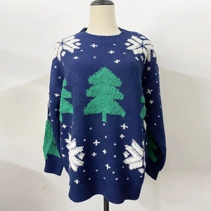 Detail of navy Christmas knit sweater featuring green 3D trees and white snowflakes