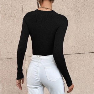 Detail of a slim-fit black ribbed knit sweater with a classic round neck and long sleeves