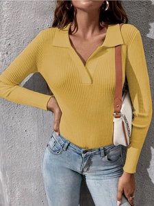 Detailed close-up of ribbed texture on a vibrant yellow long sleeve polo knit sweater
