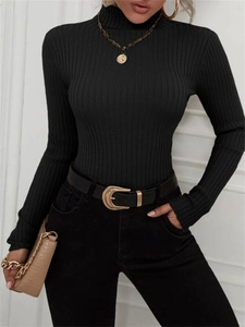Detail of black ribbed turtleneck knitwear with slim fit design and elegant metal belt