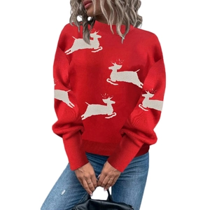 Detail of red Christmas knit sweater featuring white reindeer pattern and drop shoulders