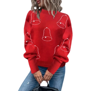 Detail shot of the red Christmas sweater featuring white bell graphics and ribbed knit texture