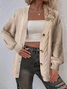 Detail showing cable knit texture and marble-pattern buttons on a beige cardigan sweater
