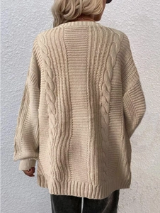Detail of beige cable-knit texture on a casual oversized women's cardigan sweater