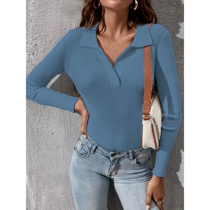 Navy ribbed knit long sleeve polo sweater with V-neckline paired with blue denim jeans
