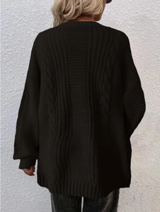 Detail of black cable knit pattern on loose long sleeve cardigan for women with drop shoulder
