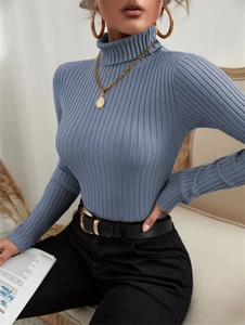 Macro detail of high neck ribbed knit texture on a blue long sleeve sweater top