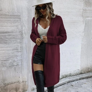 Close-up of deep wine red knitted cardigan featuring vertical stripe texture and long cuffs