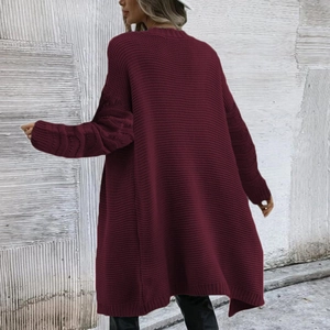 Detailed back view of long burgundy oversized knitted cardigan with chunky stitch texture
