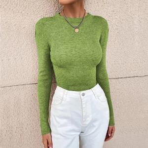 Detail of green ribbed knit sweater with crew neck and long sleeves for women