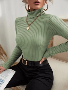 Detail of sage green ribbed knit sweater with a soft texture and mock neck collar