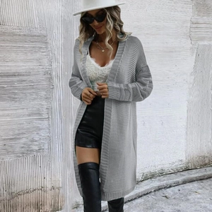 Detail of grey chunky knit cardigan texture with ribbed cuffs and hem on long sleeve top