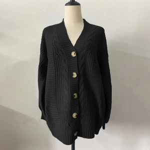 Detailed view of black cable-knit cardigan with V-neck and marble texture buttons