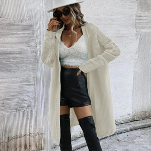 Detail of chunky knit cream cardigan showing heavy ribbed texture and relaxed fit sleeves