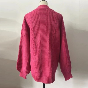 Detail view of fuchsia cable-knit sweater back with oversized loose fit design