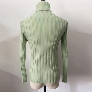 Detail view of back profile on ribbed knit sweater with high turtleneck in sage green