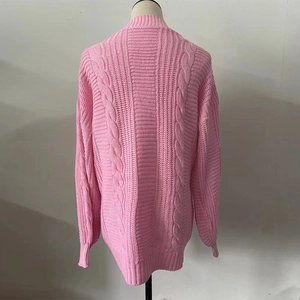 Detail view of pink cable knit cardigan back with ribbed cuffs and soft texture